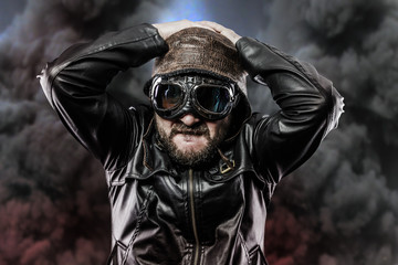 pilot with glasses and vintage hat over background explosion
