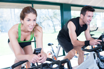 Two Friends Are In A Spinning Class At Gym