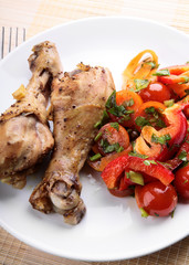 Grilled chicken legs with vegetable salad.