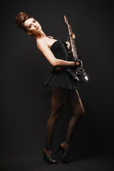 Obraz premium Rock female with guitar over dark background.
