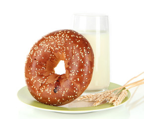 Bread roll and glass of milk isolated on white