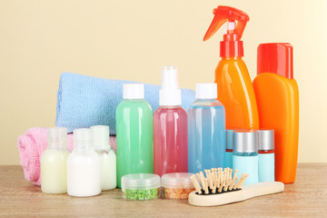 Hotel amenities kit on table on beige background