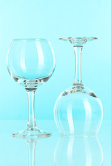 Two glasses on light blue background