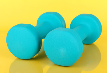 Dumbbells on yellow background