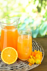 Naklejka na ściany i meble Glass and pitcher of orange juice