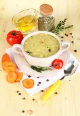 Nourishing soup in pink pan with ingredients