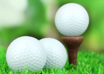 Golf balls on grass outdoor close up