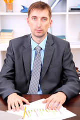 Young businessman in office at his workplace