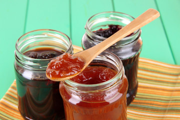 Tasty jam in banks on table close-up