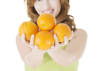 Happy woman with orange fruits