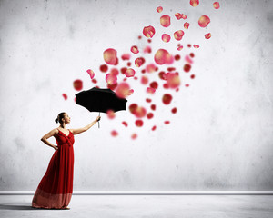 Ballet dancer in flying satin dress with umbrella