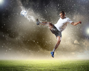 Obraz na płótnie Canvas football player striking the ball