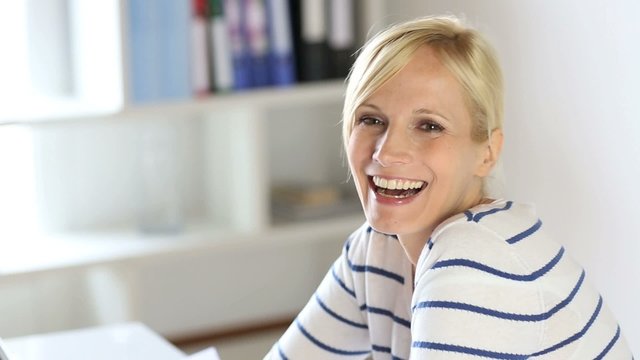 Cheerful office worker looking at camera