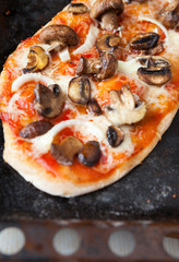 homemade pita with tomato and mushroom filling on top