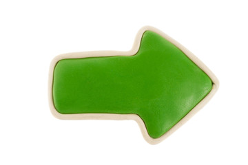 Green arrow from plasticine on a white background