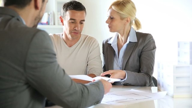 Couple signing construction contract 