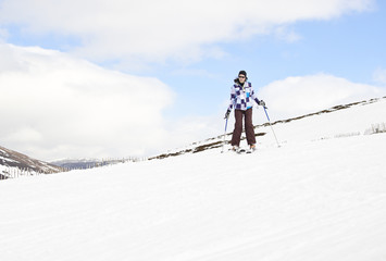 Fototapeta na wymiar Young woman enjoying ski holiday