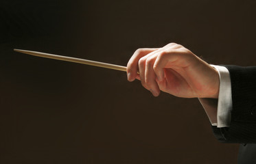 Concert conductor's hands with a baton