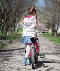 Fototapeta na wymiar little girl on her bike