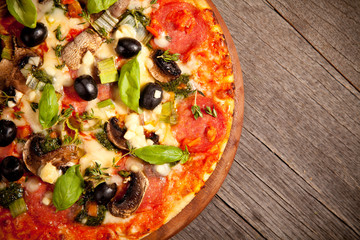 Delicious fresh pizza served on wooden table