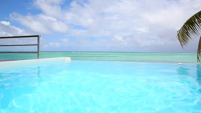 Closeup of infinty pool water with sea in background