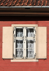 Window with shutters in an old wooden house