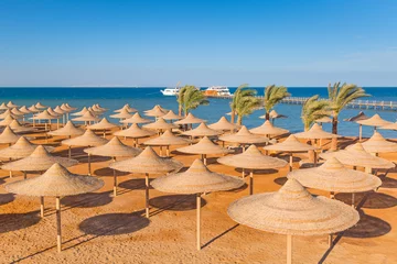 Fotobehang Egyptian parasols on the beach of Red Sea © Patryk Kosmider