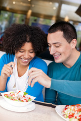 Young couple sharing salad