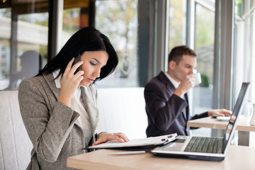 busy businesspeople working in cafe