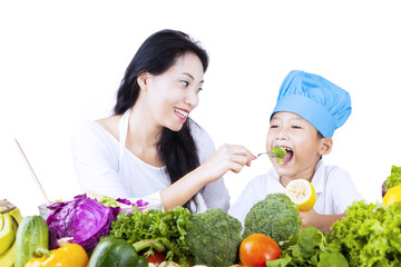 Mother feed young chef