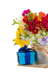 Obraz na płótnie Canvas multicolored freesia flowers with gift box