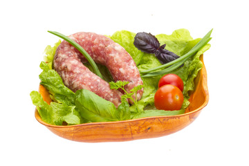 Ripe salami with salad, basil, onion and tomato