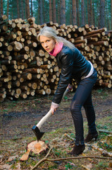 Young pretty woman with big axe