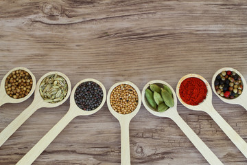 Selection of spices on wooden spoons