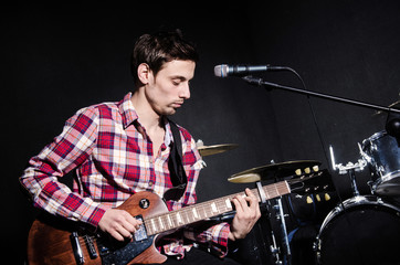 Man playing guitar during concert