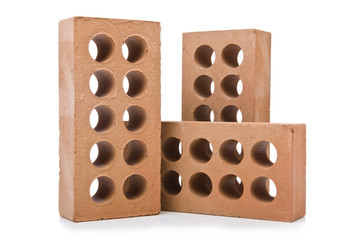 Stack of clay bricks isolated on white