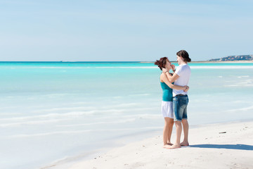 Young Couple Embraced in a Caribbean Beach