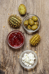 Fototapeta na wymiar Top view on various appetizers: olives, cranberry, cottage chees