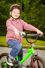 Child riding bike with safety helmet outdoors