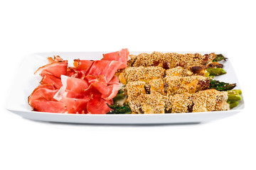 bunch of asparagus rolled with  puff pastry and speck