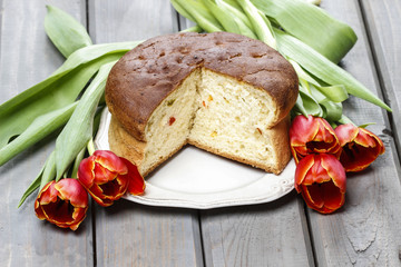 Easter table setting with yeast cake and red tulip flowers