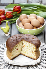 Easter table setting with eggs, yeast cake and red tulip