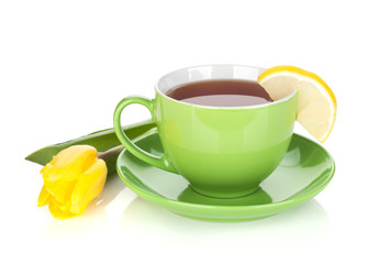 Green tea cup and yellow tulip