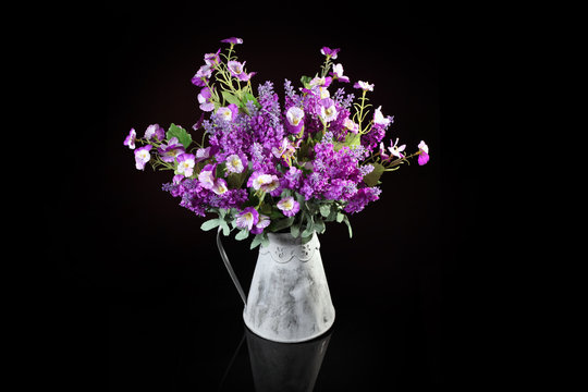 Bouquet of artificial violets and Veronica on a dark background