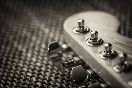 Electrical guitar headstock closeup. Sepia effect with vignette