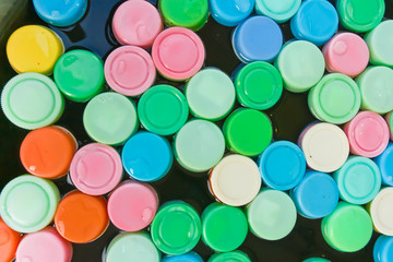 Plastic cap many colors, floating in the water.