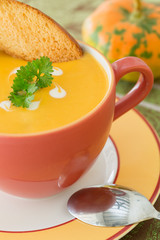 Pumpkin soup in orange bowl