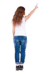 Obraz premium Back view of pointing woman