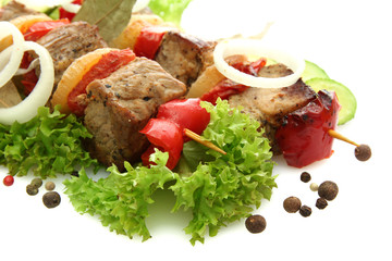 tasty grilled meat and vegetables on skewers, isolated on white