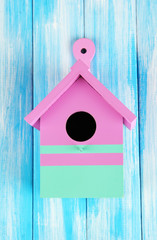 Obraz na płótnie Canvas Decorative nesting box on color wooden background